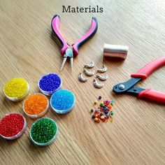 there are some crafting supplies on the table with scissors, beads and other items