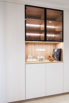 a kitchen with white cabinets and black glass doors