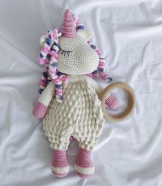 a crocheted stuffed animal with a wooden ring