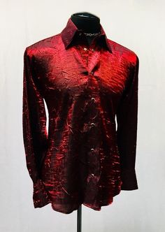 "A classic cut men's shirt with flash! Comfortable, light-weight dark red shimmer fabric adds a lot of style to a traditional cut. A generous, slimming fit fastened with rich black pearl snaps down front and at cuffs. Definitely will make you stand out in a crowd. Comes in sizes small-XXL. These shirts are large and drapey. Order a size smaller than what you usually wear. Check the measurements below. Measurements: Small: Chest 46\" Waist 42\" Medium: Chest 49\" Waist 44\" Large: Chest 52\" Wais Red Collared Party Shirt, Red Collared Shirt For Party, Red Button-up Party Tops, Fitted Red Shirt For Party, Red Fitted Collared Shirt, Fitted Red Shirt For Fall, Red Formal Shirt With Spread Collar, Red Spread Collar Top For Formal Occasions, Red Party Shirt For Fall