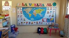 a classroom with a large map on the wall