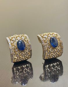 DeKara Designs Collection Metal- 18K White Gold, .750. 15.50 Grams. Stones- 2 Genuine Cabochon Oval Ceylon Blue Sapphires 5.02 Carats, 168 Round Diamonds F-G Color SI2 Clarity 2 Carats. One of a kind entirely handmade, Art Deco 18K Yellow Gold Sri Lanka Ceylon Cabochon Cut Blue Sapphire and Pave Set Diamond Art Deco Inspired One of a Kind Earrings. Each earring has an amazing oval cabochon blue sapphire that is professionally and uniquely bezel/burnish set. There are 79 round pave set diamonds o Luxury Oval Cabochon Gemstone Earrings, Elegant Blue Oval Cabochon Earrings, Designer Formal Gemstone Earrings, Designer Gemstone Earrings For Formal Occasions, Blue Cabochon Earrings For Formal Occasions, Luxury Oval Cabochon Earrings For Anniversary, Luxury Blue Sapphire Earrings, Luxury Sapphire Earrings For Formal Occasions, Luxury Formal Sapphire Earrings