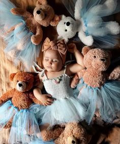 a baby is surrounded by teddy bears wearing tutus