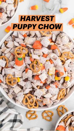 two white bowls filled with candy cornflakes and pretzels on a marble surface