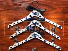 three wooden clothes hangers with blue and white polka dots on them