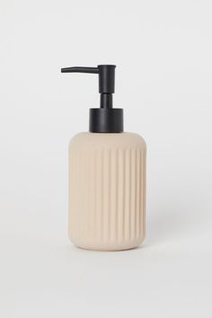 a soap dispenser on a white background with a black handle and nozzle