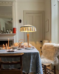 a dining room with a table and chairs next to a fire place