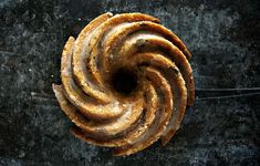 an overhead view of a pastry with icing on it's edges and cinnamon swirls in the middle