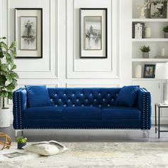 a living room with white walls and blue couches