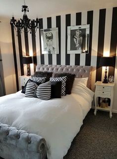 a bedroom with black and white striped walls