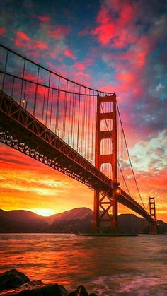 the golden gate bridge in san francisco, california at sunset with pink and blue clouds