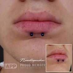 a close up of a person's nose with two piercings on the side