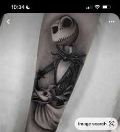 a person with a tattoo on their arm that has a jack skellingy face