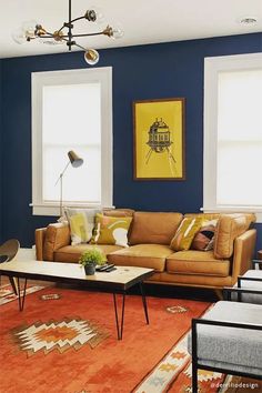 a living room with blue walls and orange carpeted area rugs on the floor