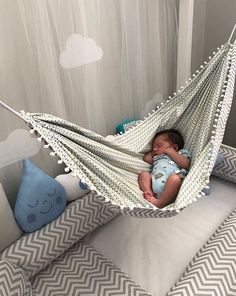 a baby is sleeping in a hammock