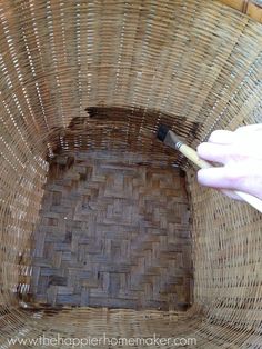 someone is painting the inside of a wicker basket