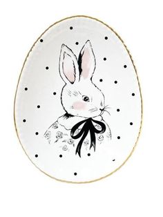 a white and black plate with a rabbit on it's face in polka dots