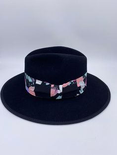 ‘Saija’ is our exclusive signature fedora that exudes luxury vibes like no other. Her name means Crowned Heads in the African language and rightfully so, as she is truly fit for a Queen. ‘Saija’ is not only a top quality fedora but she is a sure head turner and show stopper. Do not be afraid to mix her with other prints and patterns and experiment with other colors to add even more excitement to your entire look. Pair her with a blazer and jeans or a cute dress and heels and you will certainly b Modern Adjustable Fedora With Short Brim, Modern Fedora With Adjustable Fit And Short Brim, Luxury Curved Brim Fedora For Spring, Luxury Flat Brim Fedora For Spring, Modern Fitted Fedora With Short Brim, Luxury Adjustable Fedora Felt Hat, Luxury Adjustable Felt Fedora Hat, Luxury Adjustable Fedora For Kentucky Derby, Luxury Adjustable Fedora With Flat Brim