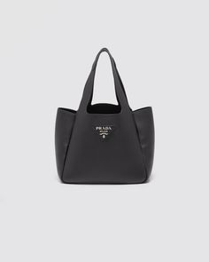 Leather Leather handles Metal lettering logo on the front Metal hardware Magnetic button closure Nappa leather interior with three compartments Prada Leather Tote, Bags Prada, Metal Lettering, Prada Tote Bag, Soft Leather Tote, Nylon Tote Bags, Lettering Logo, Prada Leather, Black Leather Tote