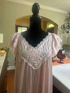 This beautiful lightweight gown is perfect for the warmer months.  The nightgown has a lace trimmed v-neckline.  The back neckline is a "v". Short, flouncy sleeves with narrow lace trim. In good vintage condition with no rips or stains.  The tag indicates Vanity Fair size medium.  The bust measures 21 inches from armpit to armpit laying flat, 40 inches from shoulder to hem.  Please examine the pics, feel free to ask questions. Summer Nightgown, Flouncy Sleeves, Nightgown Vintage, Victorian Nightgown, Vintage Vanity Fair, Vintage Nightgown, Women's Nightgowns, Nightgowns For Women, Vintage Vanity