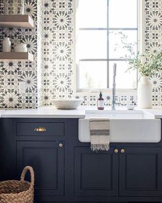 a white sink sitting under a window in a kitchen