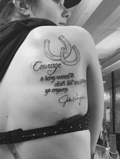 a woman with a tattoo on her back saying, courage is being heard to people