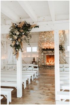 an empty church with white benches and candles