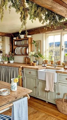 a kitchen filled with lots of counter top space and wooden flooring next to a window