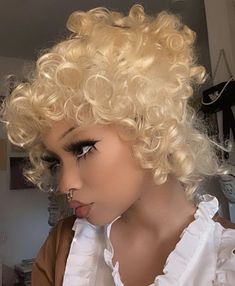 a blonde wig with curly hair and black eyeliners