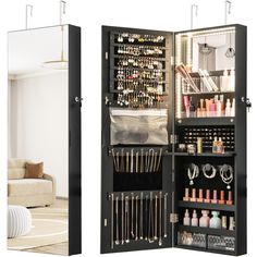 the inside of a mirrored cabinet is shown with jewelry and makeup items in its storage compartment