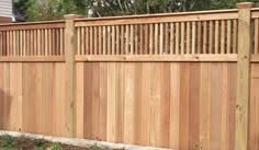 a wooden fence in front of a house