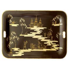 a black and gold tray with an image of people in the sky on it, as well as clouds