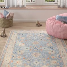 a pink and white rug in front of a window with two stuffed animals on the floor