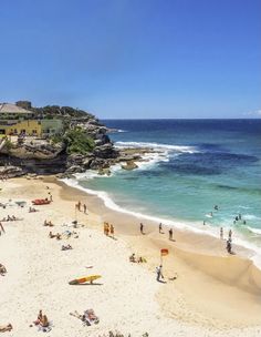 many people are on the beach and in the water