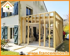 a house being built with wooden framing in the foreground and an orange frame around it