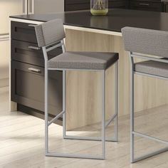 two gray chairs sitting on top of a kitchen counter