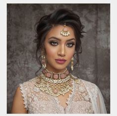 a woman wearing an elaborate necklace and earrings