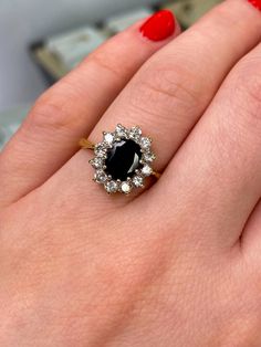 a woman's hand with a black and white diamond ring