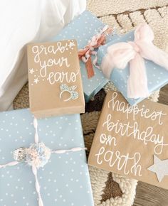 three wrapped presents sitting on top of a rug next to each other with congratulations written on them