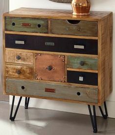 an old dresser with drawers and metal knobs on it's legs is shown