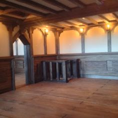 an empty room with wooden floors and beams