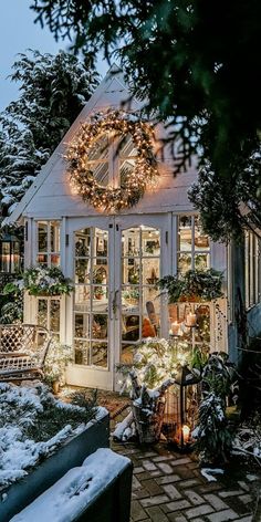 a house decorated with christmas lights and wreaths