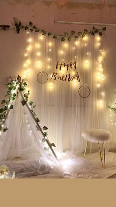 a teepee with lights on it and a happy birthday sign