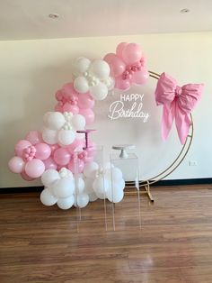 balloons and bows are arranged in the shape of a happy birthday arch for a party