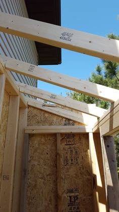 the inside of a house being built with wooden framing and roof trusss on it