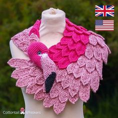 a crocheted scarf with a pink bird on it and an american flag in the background