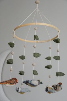 a mobile with birds and leaves hanging from it