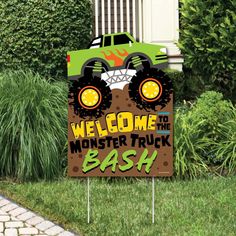 a welcome sign with a monster truck on it in front of some grass and bushes