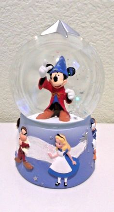 a snow globe with mickey mouse and other figurines