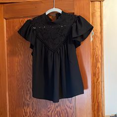 Brand New With Tags. From Express Size Small, Black , Baby Doll Shirt With Ruffle Sleeves And Detail On Top. Very Pretty. Two Buttons In The Back Around The Neck. Black Lace Top Blouse With Short Sleeves, Fitted Flutter Sleeve Top For Night Out, Black Flutter Sleeve Tops For Spring, Black Short Sleeve Top With Ruffles, Casual Flutter Sleeve Tops For Night Out, Casual Black Top With Flutter Sleeves, Black Ruffled Short Sleeve Tops, Black Flutter Sleeve Fitted Blouse, Black Short Sleeve Blouse With Ruffles